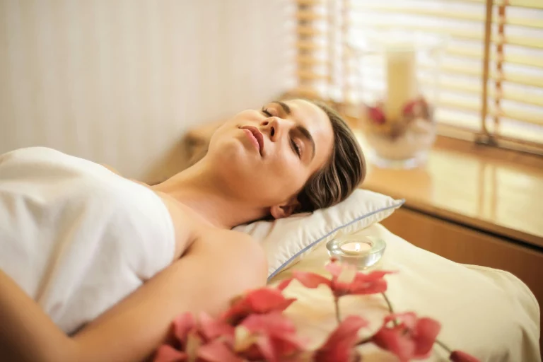 A woman lying with her eyes closed.