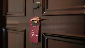 Featured Image: a do not disturb sign on the motel door.